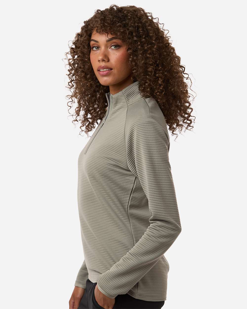 Woman wearing a green long-sleeve athletic top on a white background. Adidas Women's Spacer Quarter-Zip Pullover, Embroidered by Helmsman Stitch Co.