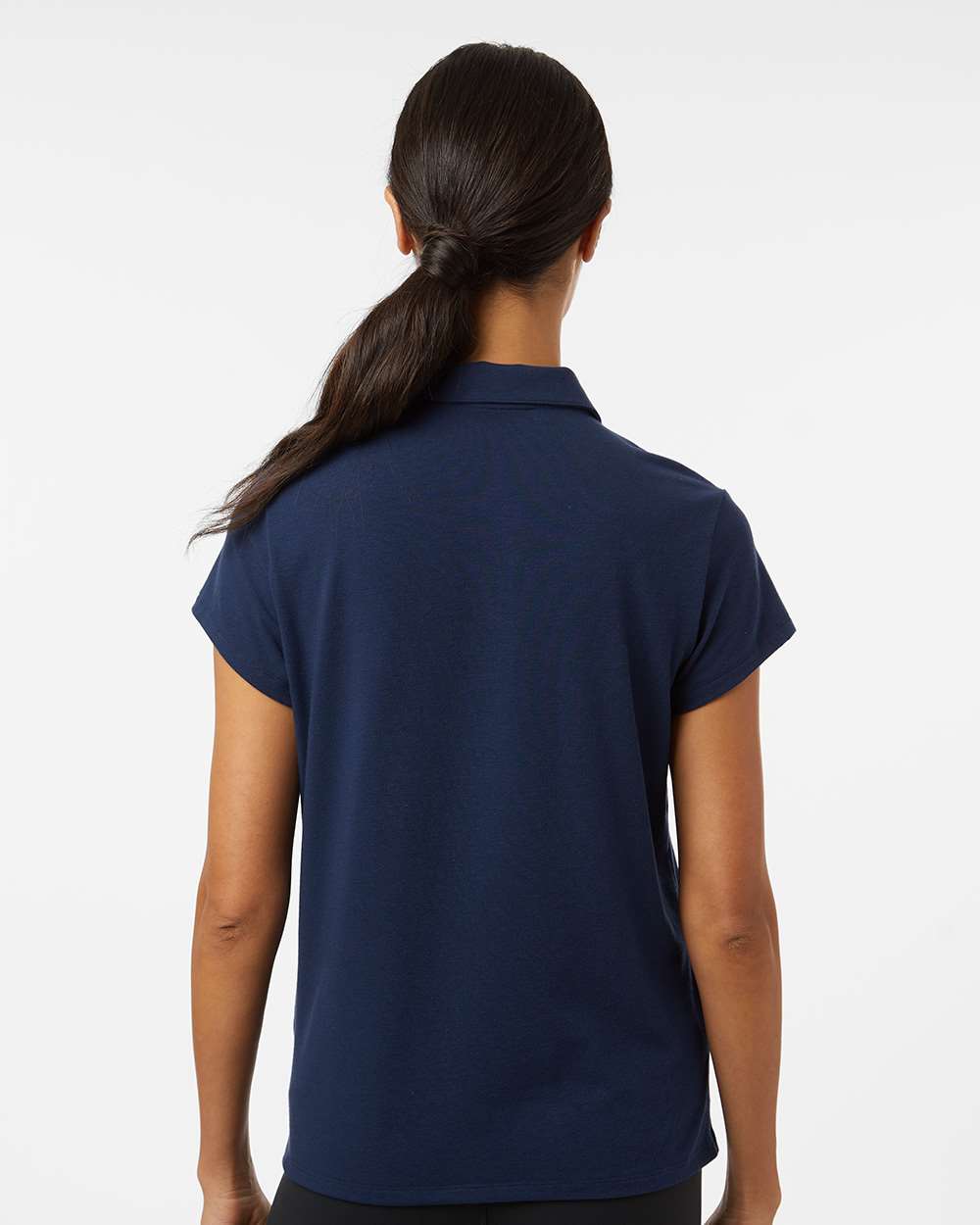 Person wearing a navy blue polo shirt on a white background. Adidas Women's Blended Polo, Embroidered by helmsman Stitch Co.