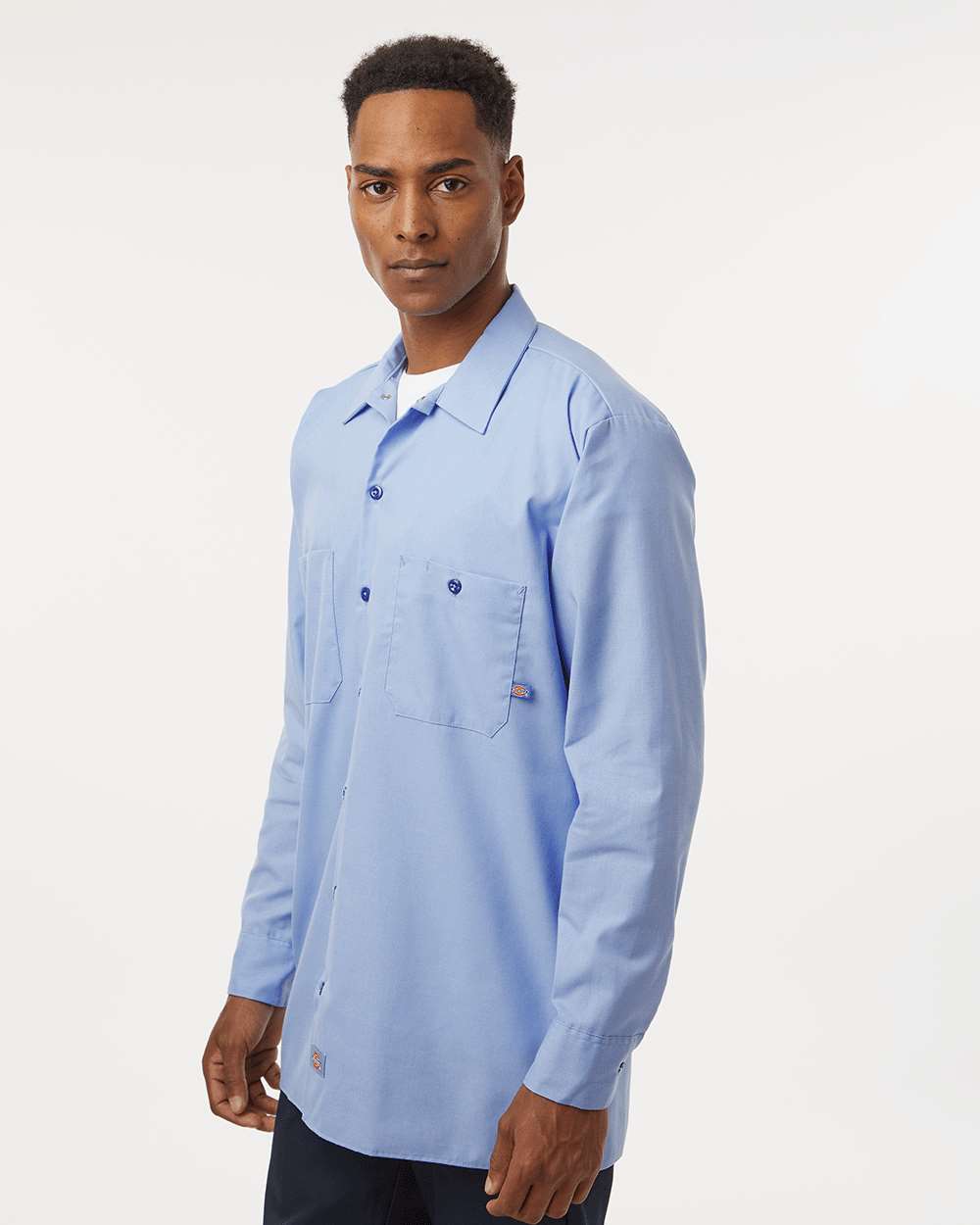 Man wearing a light blue shirt on a white background. Dickie's Men's Industrial long Sleeve Work Shirt, Embroidered by Helmsman Stitch Co.
