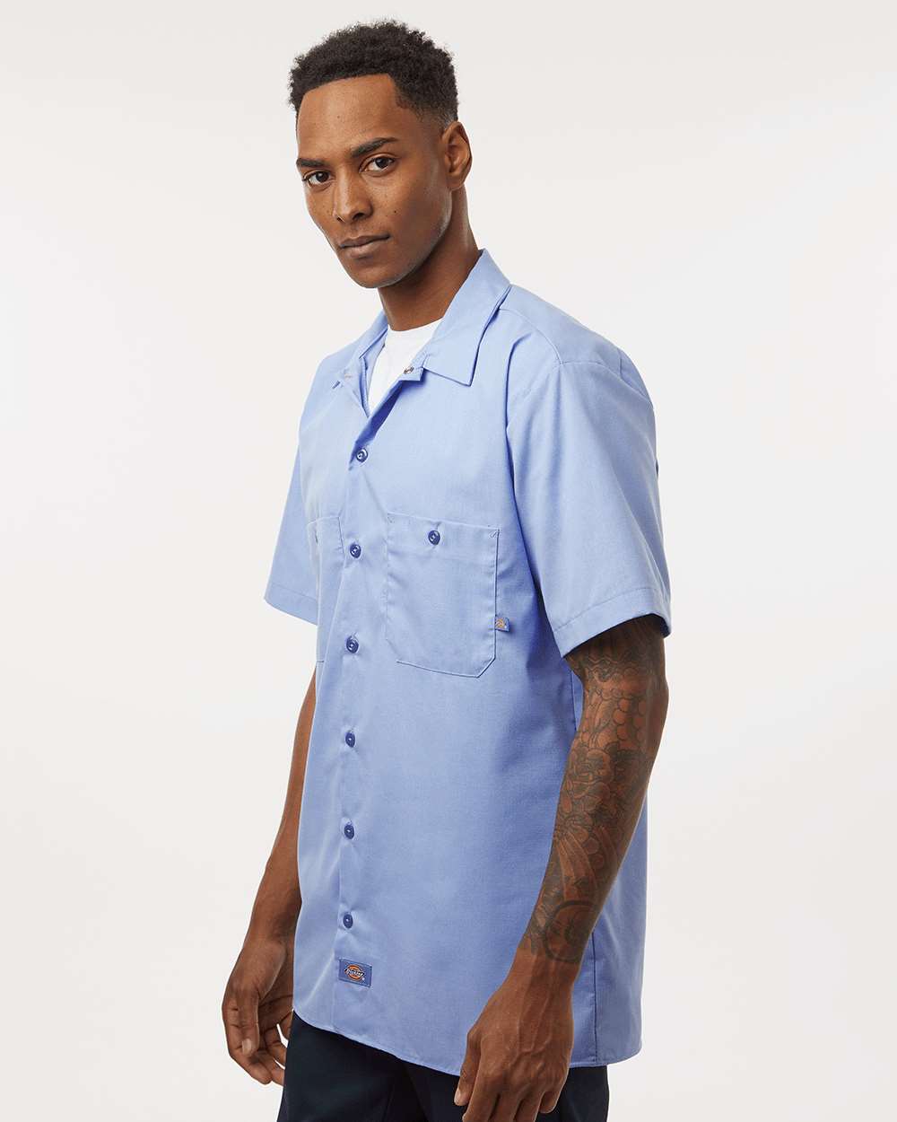 Man wearing a light blue short-sleeve shirt on a white background. Dickie's Men's Industrial Short Sleeve Work Shirt, Embroidered by Helmsman Stitch Co.