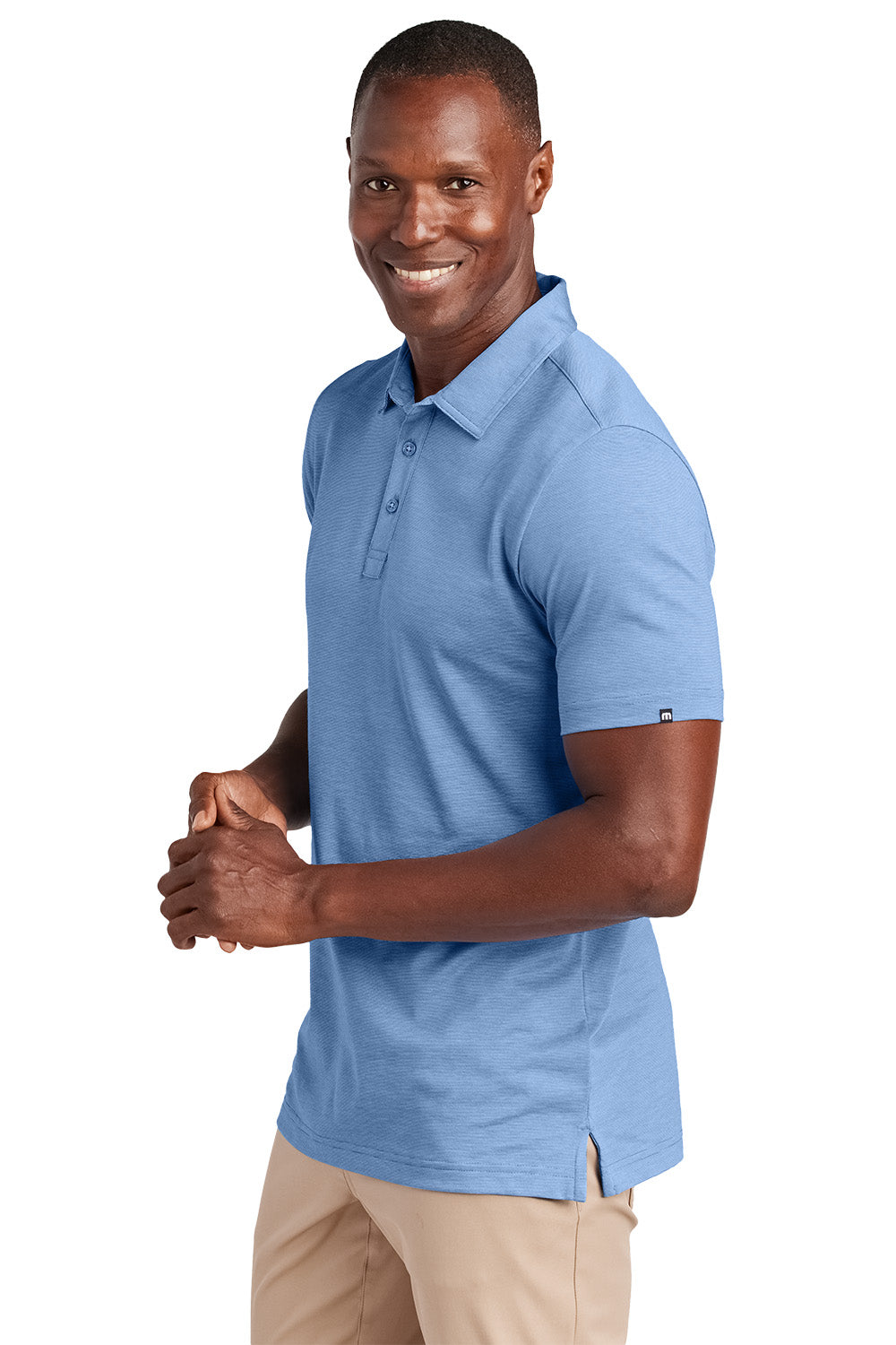 Man wearing a blue polo shirt on a white background, Embroidered TravisMathew Sunnyvale Polo