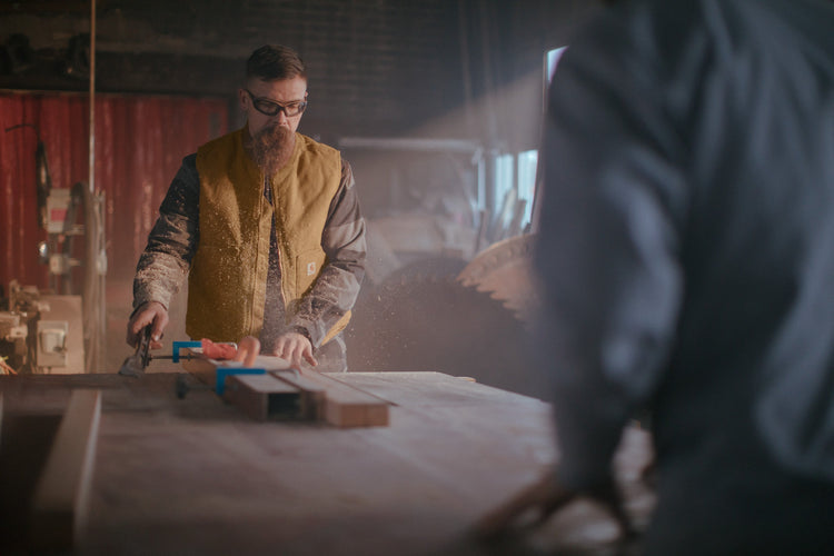 man working with his hands, wearing a vest ready for embroidery