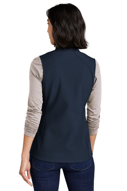 Woman wearing a navy vest over a beige long-sleeve shirt on a white background embroidered Eddie Bauer® Women's Stretch Soft Shell Vest