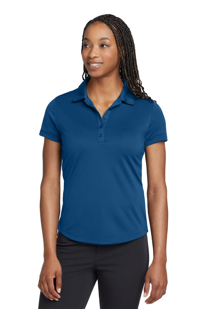 Woman wearing a blue polo shirt on a white background, embroidered Nike Women's Dri-FIT Players Modern Fit Polo
