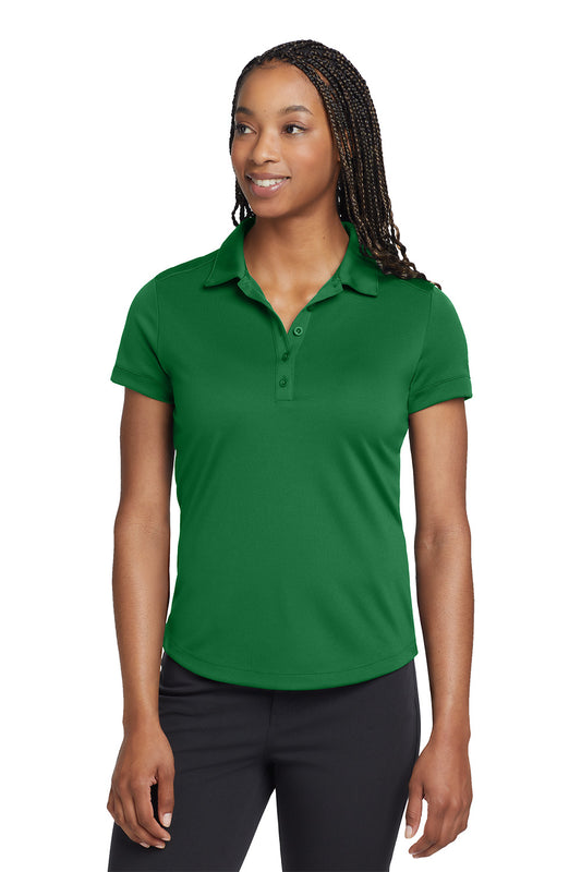 Woman wearing a green polo shirt on a white background, embroidered Nike Women's Dri-FIT Players Modern Fit Polo