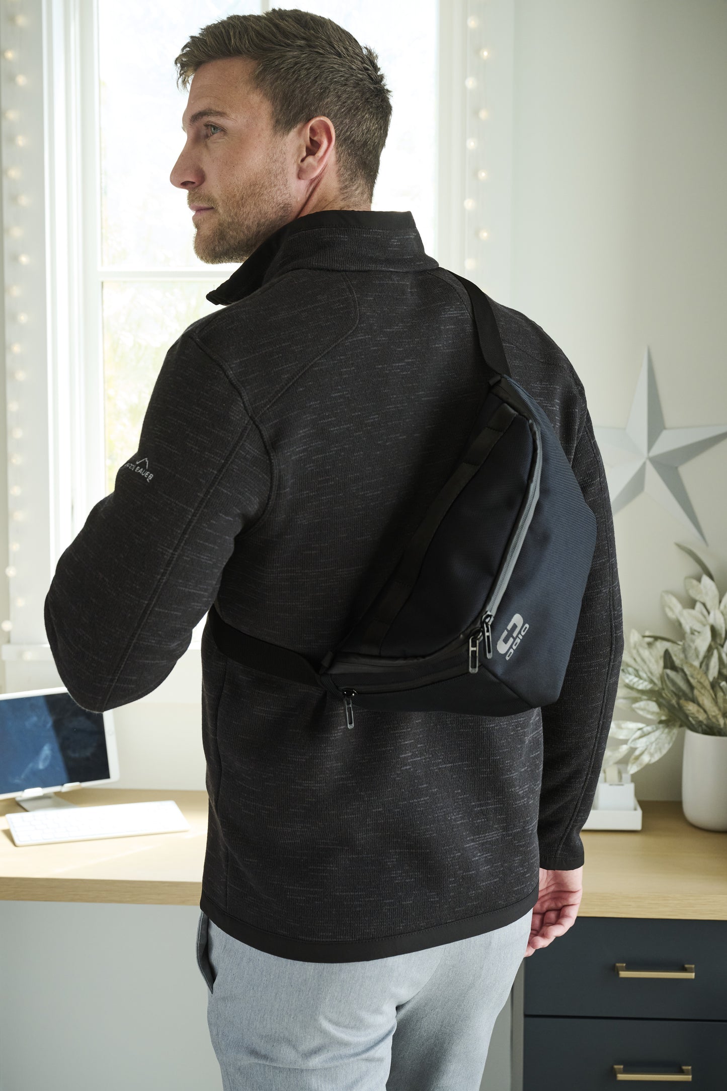 Man wearing a black jacket with a backpack in an indoor setting, Eddie Bauer® Sweater Fleece Full-Zip, Embroidered