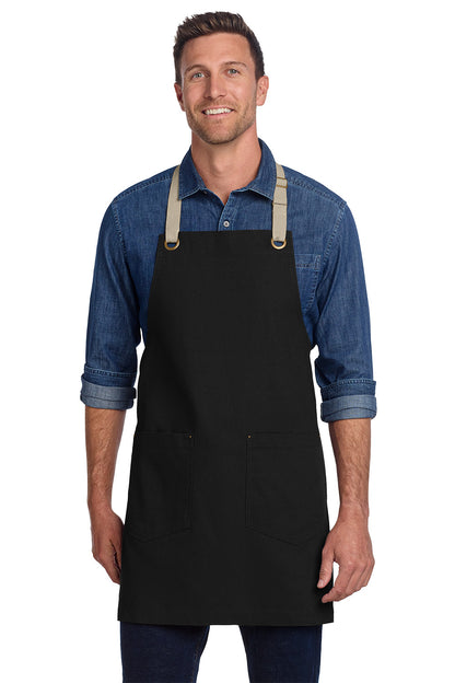 Man wearing a black apron over a blue denim shirt on a white background, Port Authority® Canvas Full-Length Two-Pocket Apron, Embroidered