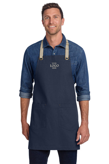 Man wearing a navy apron with customizable logo text on a white background, Port Authority® Canvas Full-Length Two-Pocket Apron, Embroidered