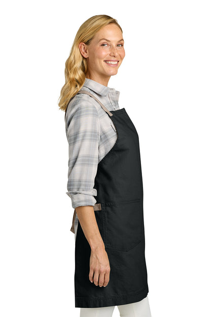 Woman wearing a black apron on a white background. Port Authority® Signature Heavy Twill Crossback Apron, Embroidered