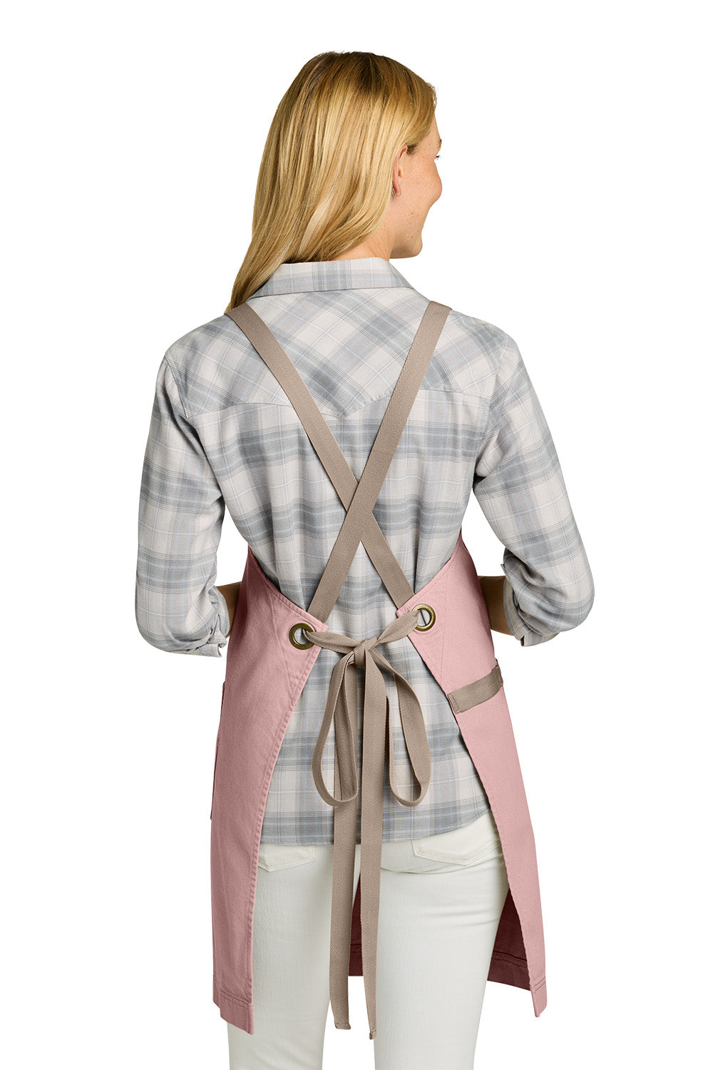 Woman wearing a pink apron with a brown strap over a plaid shirt on a white background Port Authority® Signature Heavy Twill Crossback Apron, Embroidered