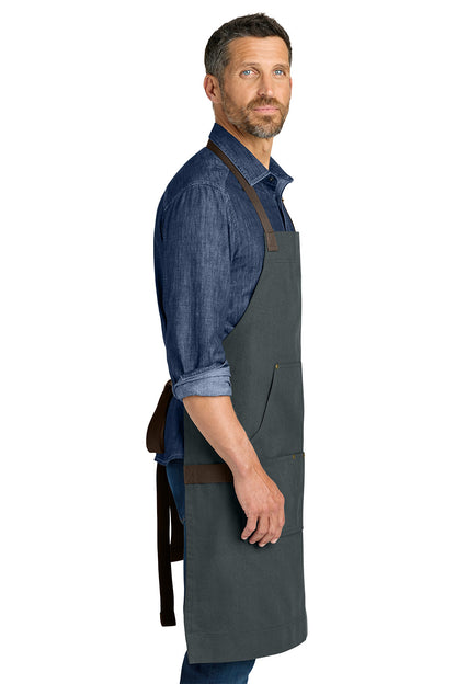 Man wearing a gray apron with brown straps on a white background Port Authority® Signature Workwear Apron, Embroidered
