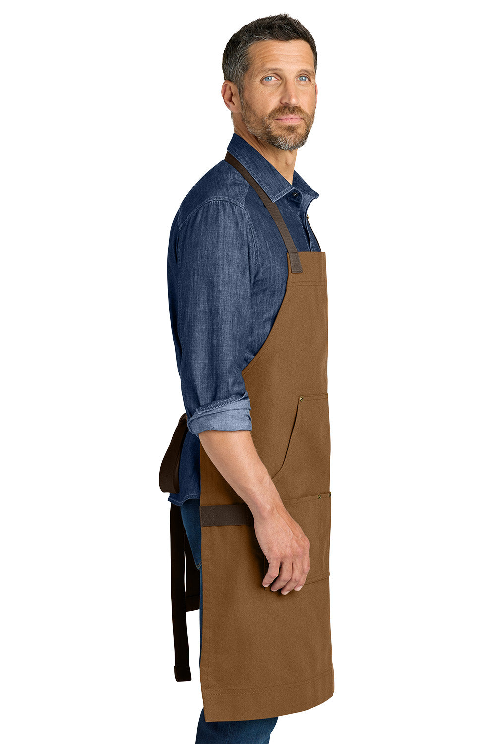 Man wearing a brown apron over a blue shirt on a white background Port Authority® Signature Workwear Apron, Embroidered