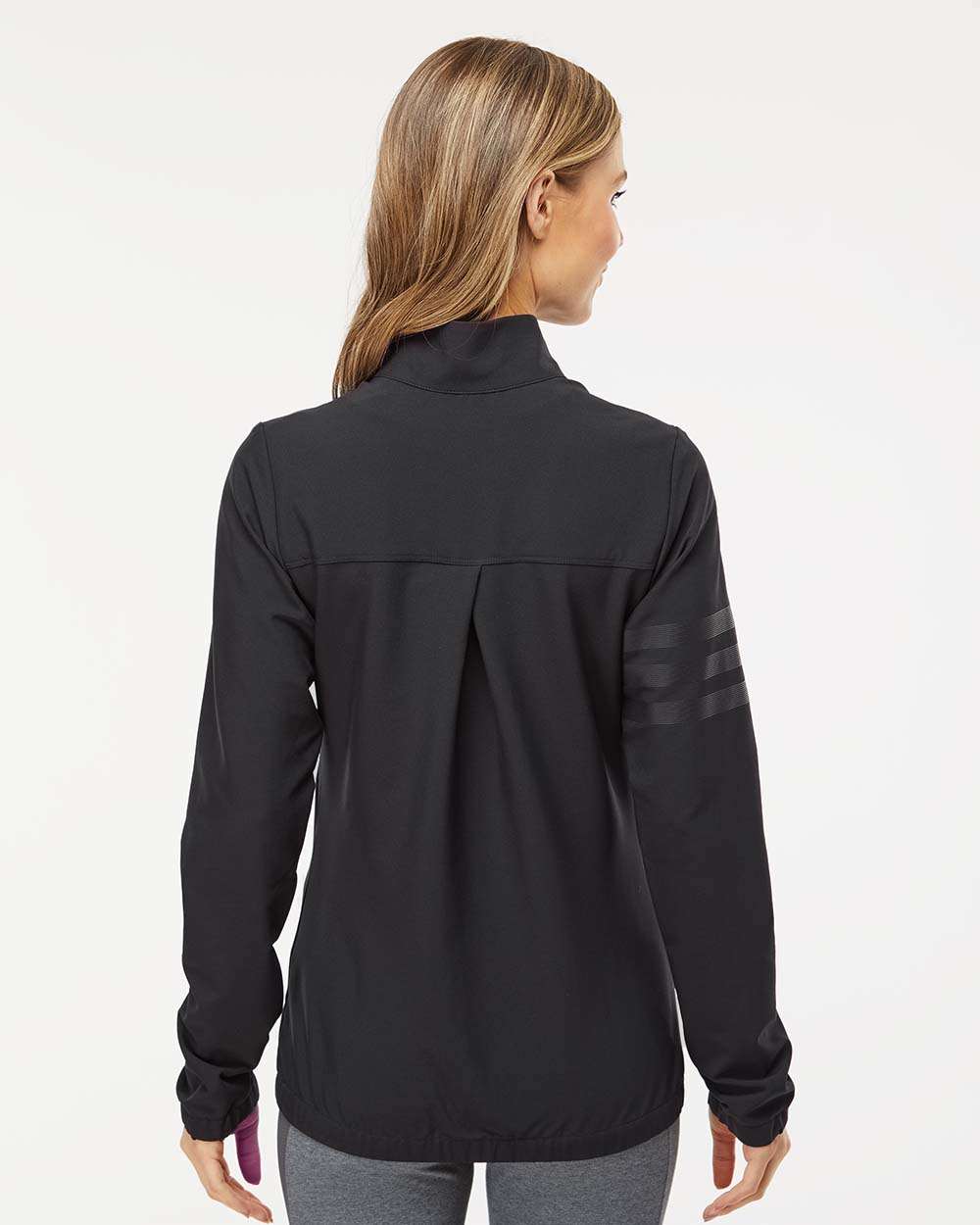 Woman wearing a black jacket on a white background. Adidas Women's Wind Resistant Full-Zip Jacket, Embroidered by Helmsman Stitch Co.