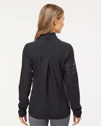 Woman wearing a black jacket on a white background. Adidas Women's Wind Resistant Full-Zip Jacket, Embroidered by Helmsman Stitch Co.