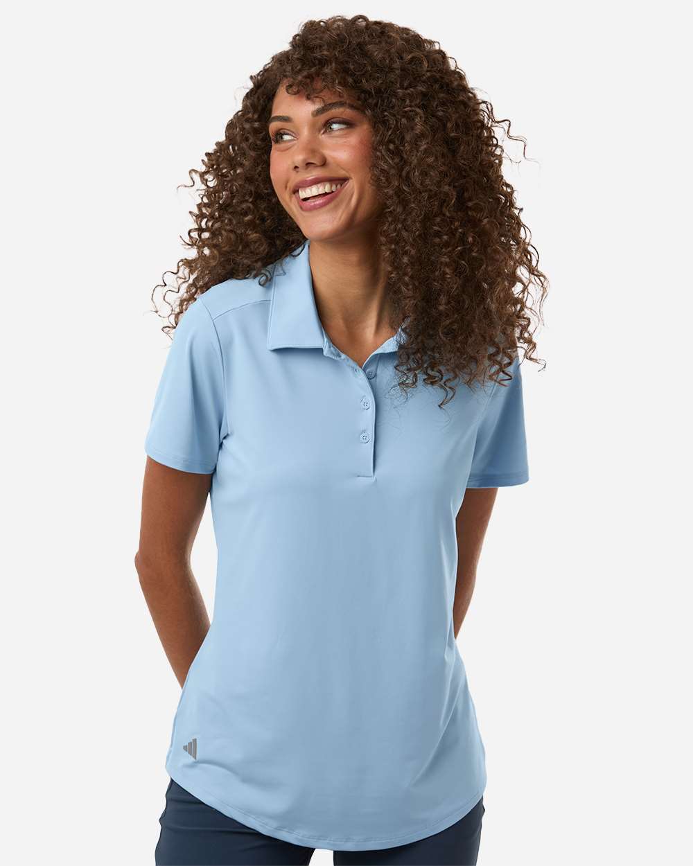 Woman wearing a light blue polo shirt on a white background. Adidas Women's Ultimate365 Solid Polo, Embroidered by Helmsman Stitch Co.