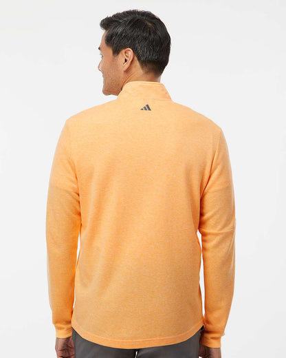 Person wearing an orange Adidas jacket on a white background. Men's 3-Stripes Quarter-Zip Sweater Pullover, Embroidered by Helmsman Stitch Co.