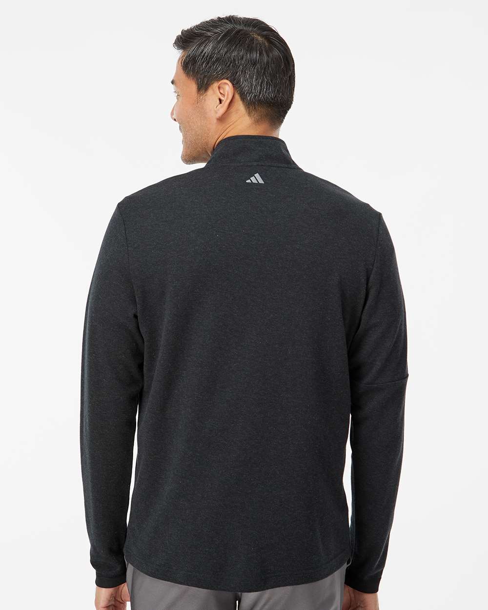Man wearing a black Adidas jacket on a white background. Men's 3-Stripes Quarter-Zip Sweater Pullover, Embroidered by Helmsman Stitch Co.