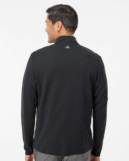 Man wearing a black Adidas jacket on a white background. Men's 3-Stripes Quarter-Zip Sweater Pullover, Embroidered by Helmsman Stitch Co.