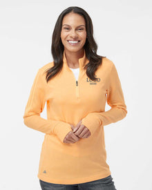 Woman wearing an orange long-sleeve shirt with a visible brand logo on a white background. Adidas Women's 3-Stripes Quarter-Zip Sweater Pullover, Embroidered by Helmsman Stitch Co.