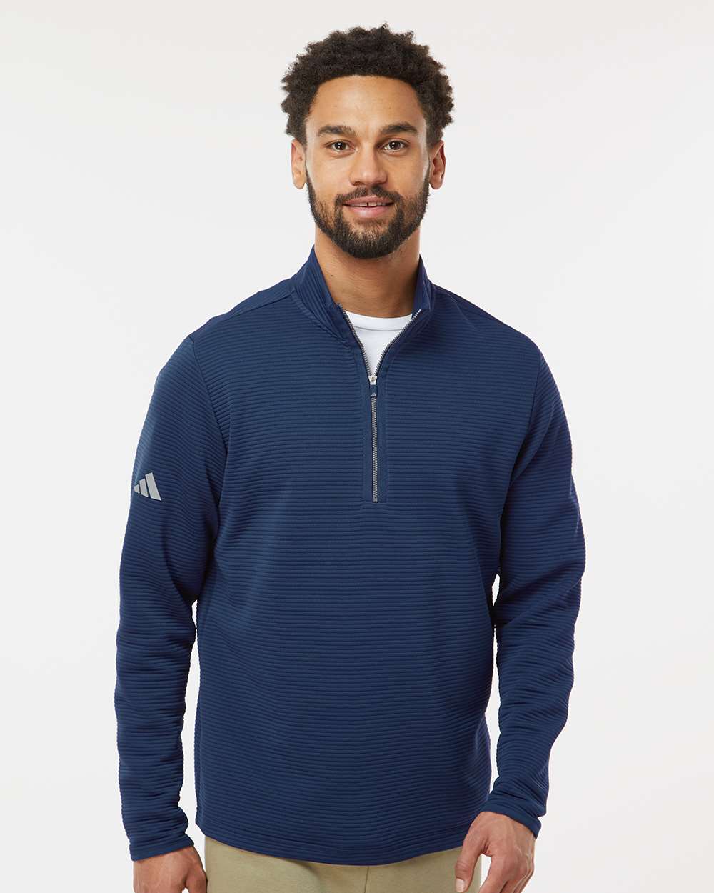 Man wearing a blue Adidas pullover on a white background. Adidas Men's Spacer Quarter-Zip Pullover, Embroidered