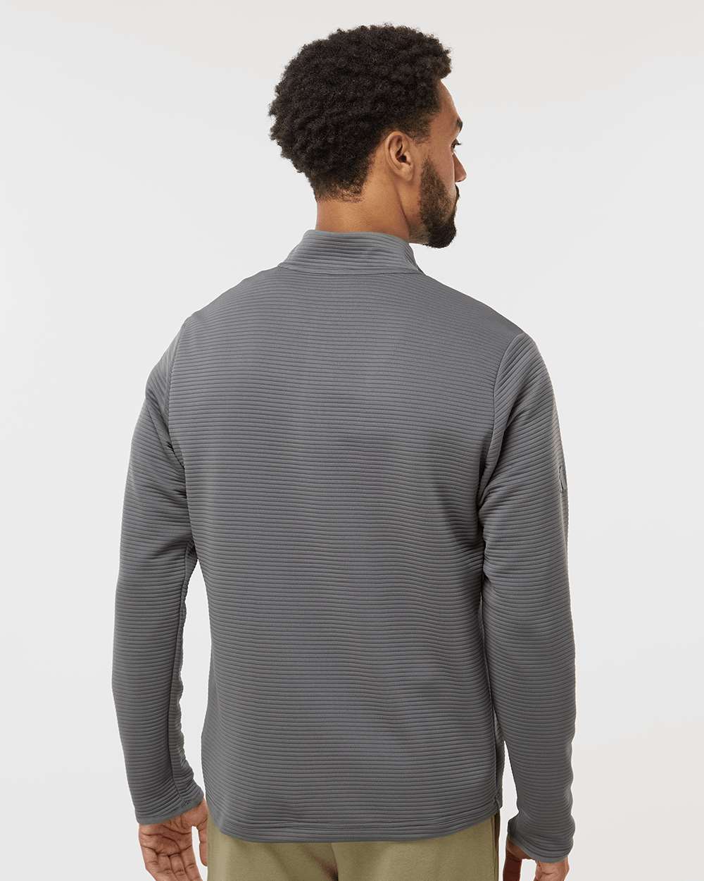Man wearing a gray long-sleeve shirt against a white background. Adidas Men's Spacer Quarter-Zip Pullover, Embroidered by Helmsman Stitch Company