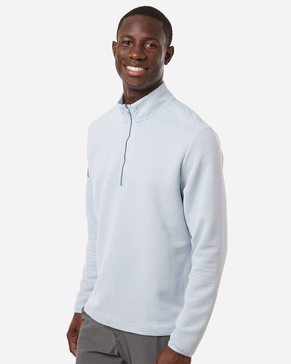 Man wearing a light gray long-sleeve shirt with a quarter zip on a white background. Adidas Men's Spacer Quarter-Zip Pullover, Embroidered by Helmsman Stitch Company