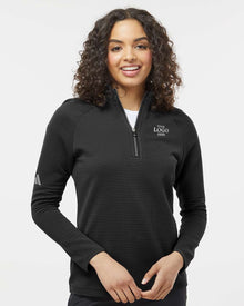 Woman wearing a black long-sleeve shirt with a logo on a white background. Adidas Women's Spacer Quarter-Zip Pullover, Embroidered by Helmsman Stitch Co.