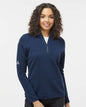 Woman wearing a blue Adidas pullover on a white background. Adidas Women's Spacer Quarter-Zip Pullover, Embroidered by Helmsman Stitch Co.