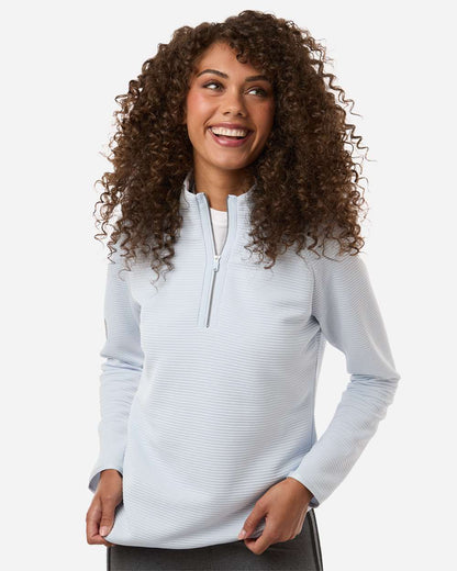 Woman wearing a light gray long-sleeve shirt with a quarter zip on a white background. Adidas Women's Spacer Quarter-Zip Pullover, Embroidered by Helmsman Stitch Co.