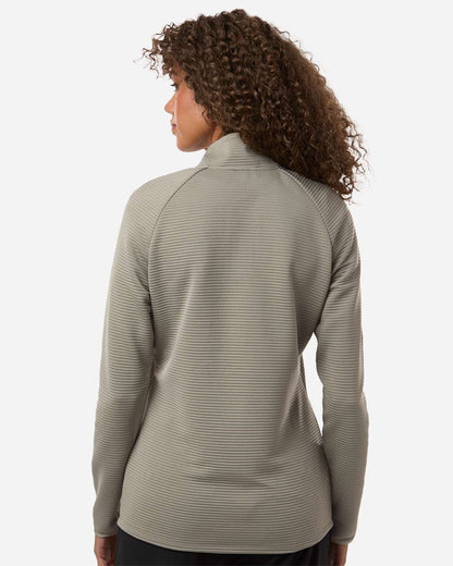 Woman wearing a gray long-sleeve top on a white background. Adidas Women's Spacer Quarter-Zip Pullover, Embroidered by Helmsman Stitch Co.