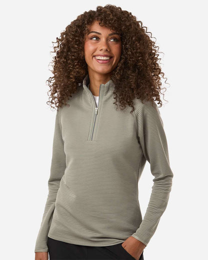 Woman wearing a light gray long-sleeve shirt with a quarter zip on a white background. Adidas Women's Spacer Quarter-Zip Pullover, Embroidered by Helmsman Stitch Co.
