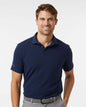 Man wearing a navy blue polo shirt on a white background. Adidas Men's Blended Polo, Embroidered by Helmsman Stitch Co.