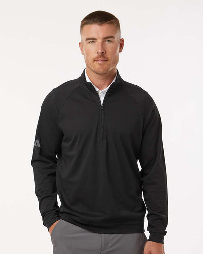 Man wearing a black quarter-zip pullover with a white background. Adidas Men's Club Quarter-Zip Pullover, Embroidered by Helmsman Stitch Co.