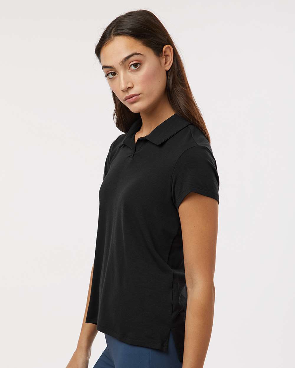 Woman wearing a black polo shirt against a white background. Adidas Women's Blended Polo, Embroidered by helmsman Stitch Co.