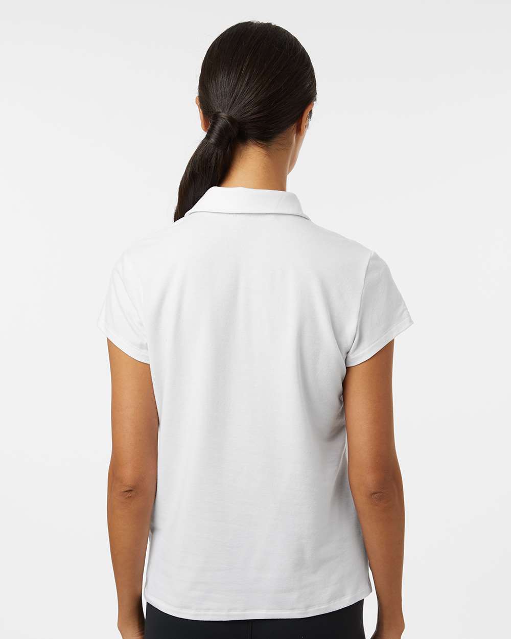 Person wearing a white polo shirt on a plain background. Adidas Women's Blended Polo, Embroidered by helmsman Stitch Co.