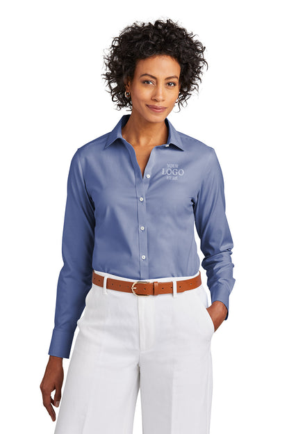 Woman wearing a blue shirt with a logo, white pants, and a brown belt on a white background embroidered Brooks Brothers® Women’s Wrinkle-Free Stretch Pinpoint Shirt