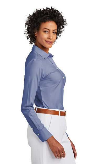 Woman wearing a blue dress shirt and white pants on a white background embroidered Brooks Brothers® Women’s Wrinkle-Free Stretch Pinpoint Shirt