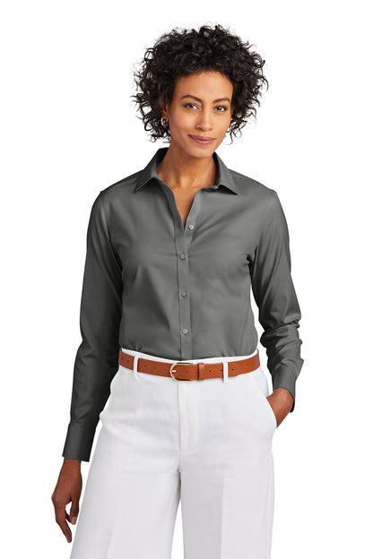 Woman wearing a gray button-up shirt and white pants with a brown belt on a white background embroidered Brooks Brothers® Women’s Wrinkle-Free Stretch Pinpoint Shirt