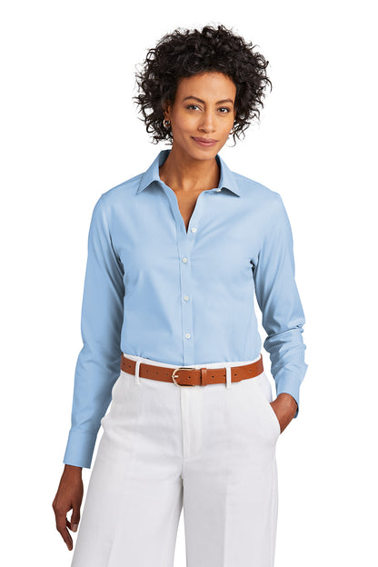 Woman wearing a light blue button-up shirt and white pants on a white background embroidered Brooks Brothers® Women’s Wrinkle-Free Stretch Pinpoint Shirt
