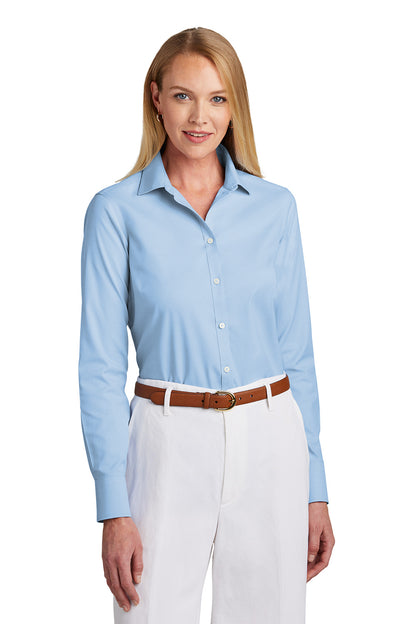 Woman wearing a light blue shirt and white pants with a brown belt on a white background embroidered Brooks Brothers® Women’s Wrinkle-Free Stretch Pinpoint Shirt