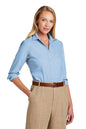 Woman wearing a light blue shirt and beige pants on a white background embroidered Brooks Brothers® Women’s Wrinkle-Free Stretch Nailhead Shirt