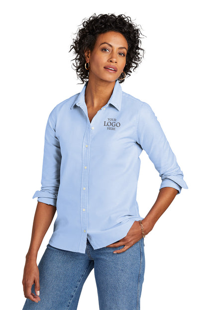 Woman wearing a light blue button-up shirt with a logo on a white background embroidered Brooks Brothers® Women’s Casual Oxford Cloth Shirt