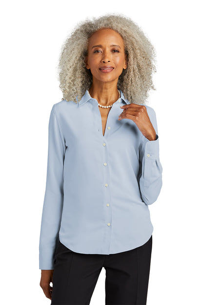 Woman wearing a light blue button-up shirt on a white background embroidered Brooks Brothers® Women’s Full-Button Satin Blouse