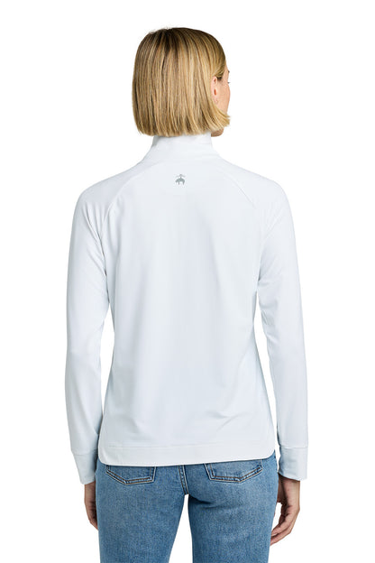 Woman wearing a light blue long-sleeve shirt with a small logo on the back, standing against a white background. Brooks Brothers® Women's Luxe Performance 1/4-Zip, Embroidered
