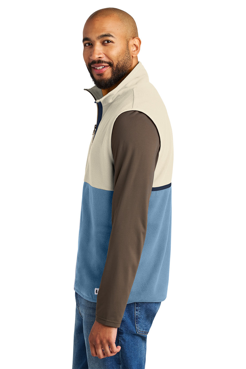 Man wearing a three-color pullover with beige, brown, and blue sections on a white background, Embroidered Cotopaxi® Amado Fleece Vest