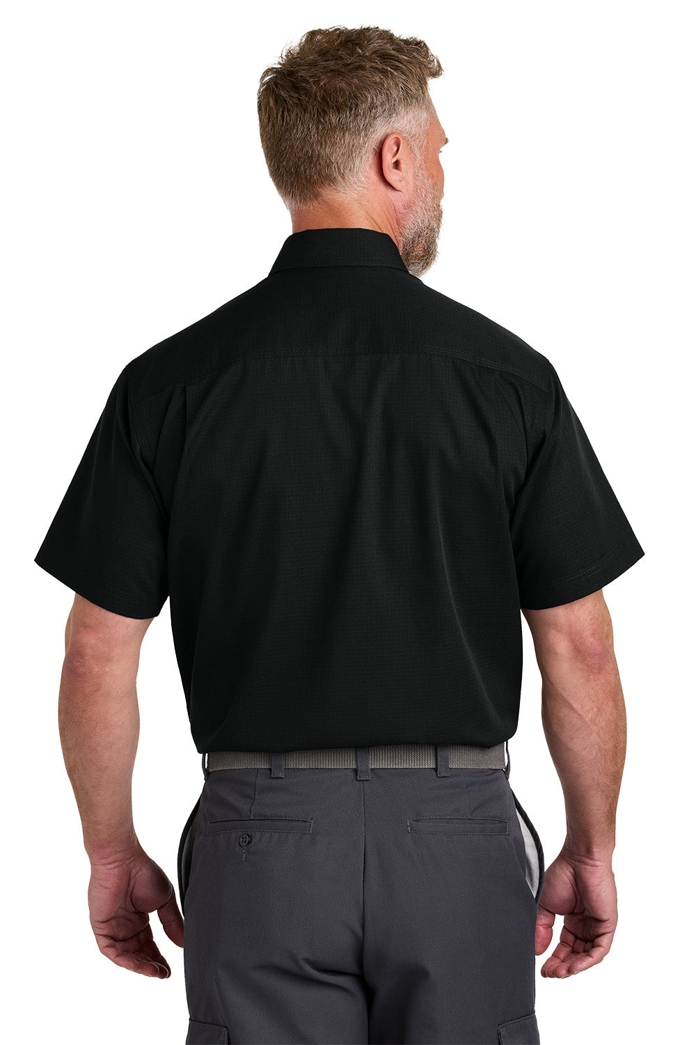 Man wearing a black short-sleeve shirt and gray pants on a white background emroidered CornerStone® Short Sleeve Select Ripstop Shirt
