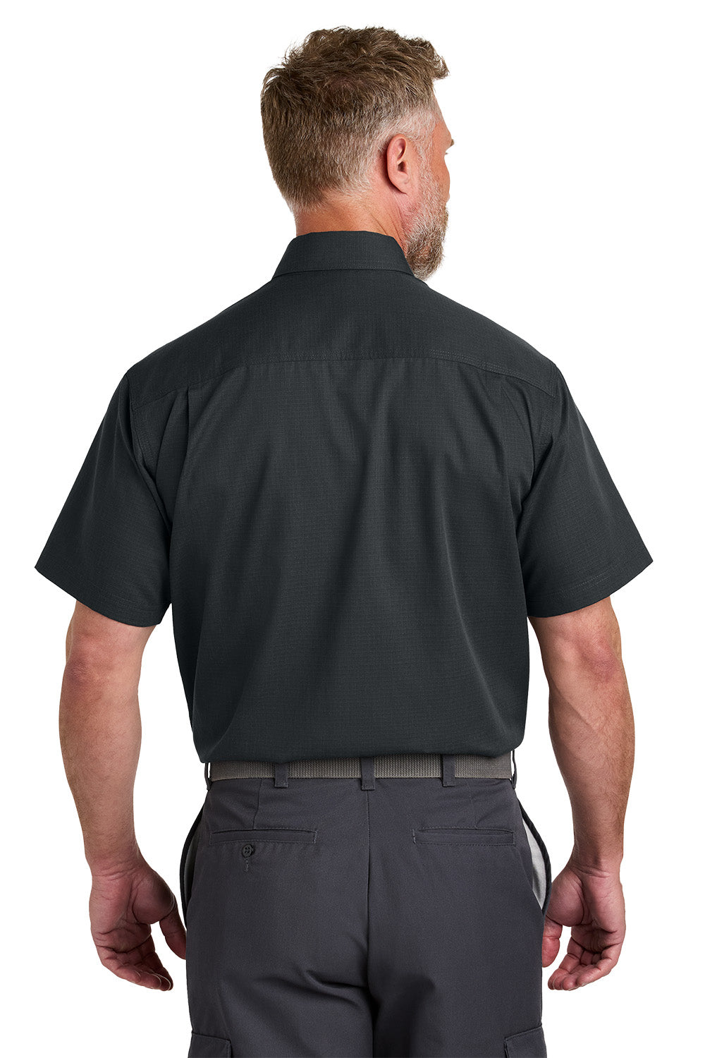 Man wearing a black short-sleeve shirt and gray pants on a white background emroidered CornerStone® Short Sleeve Select Ripstop Shirt