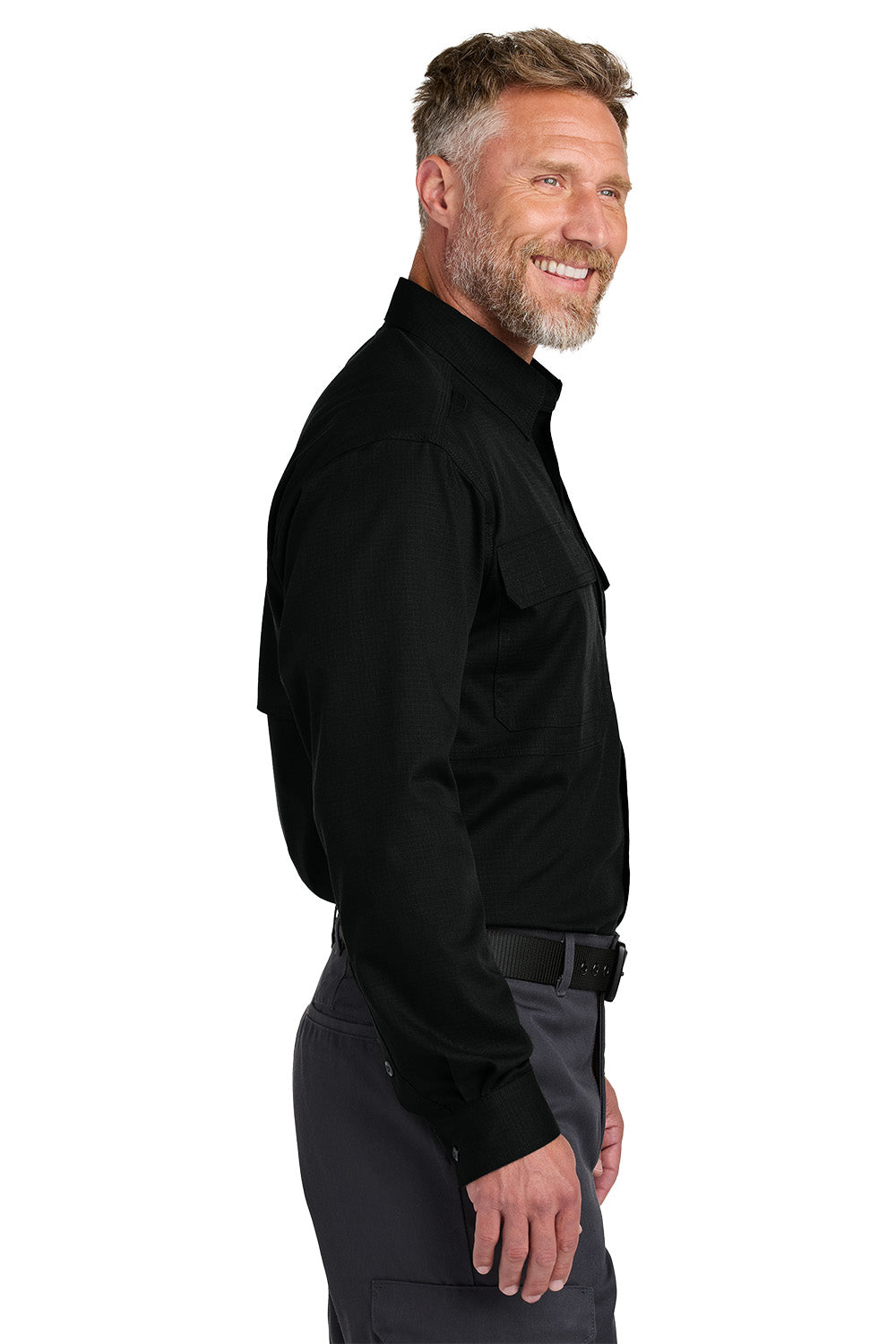Man wearing a black long-sleeve shirt and gray pants on a white background embroidered CornerStone® Long Sleeve Select Tactical Shirt