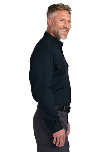 Man wearing a black shirt and gray pants on a white background embroidered CornerStone® Long Sleeve Select Tactical Shirt
