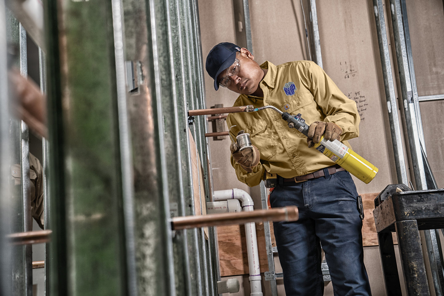 Person using a welding torch in an industrial setting embroidered Carhartt Force® Solid Long Sleeve Shirt